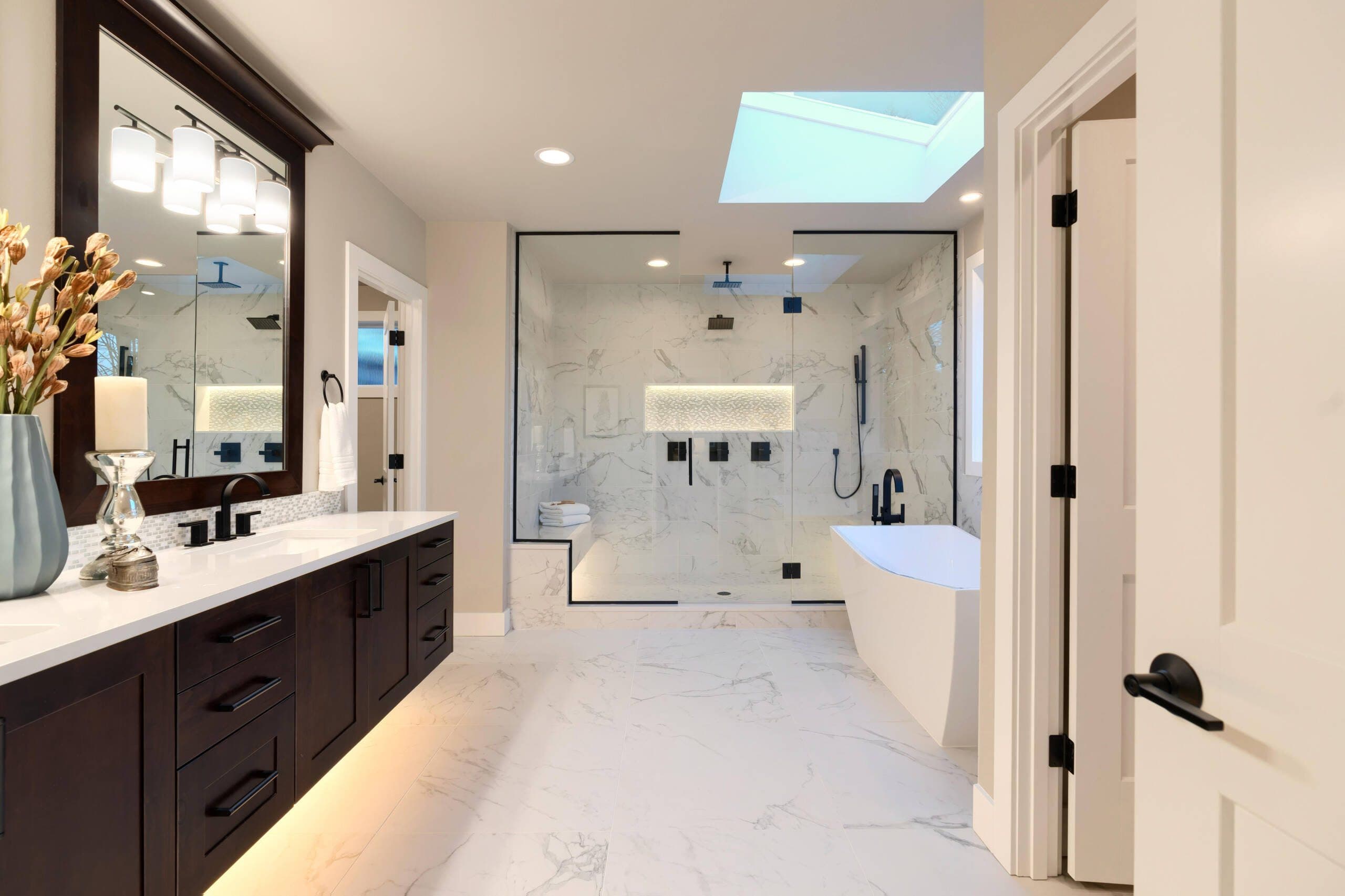 Modern luxury bathroom remodel in Southlake, TX with marble and frameless glass shower