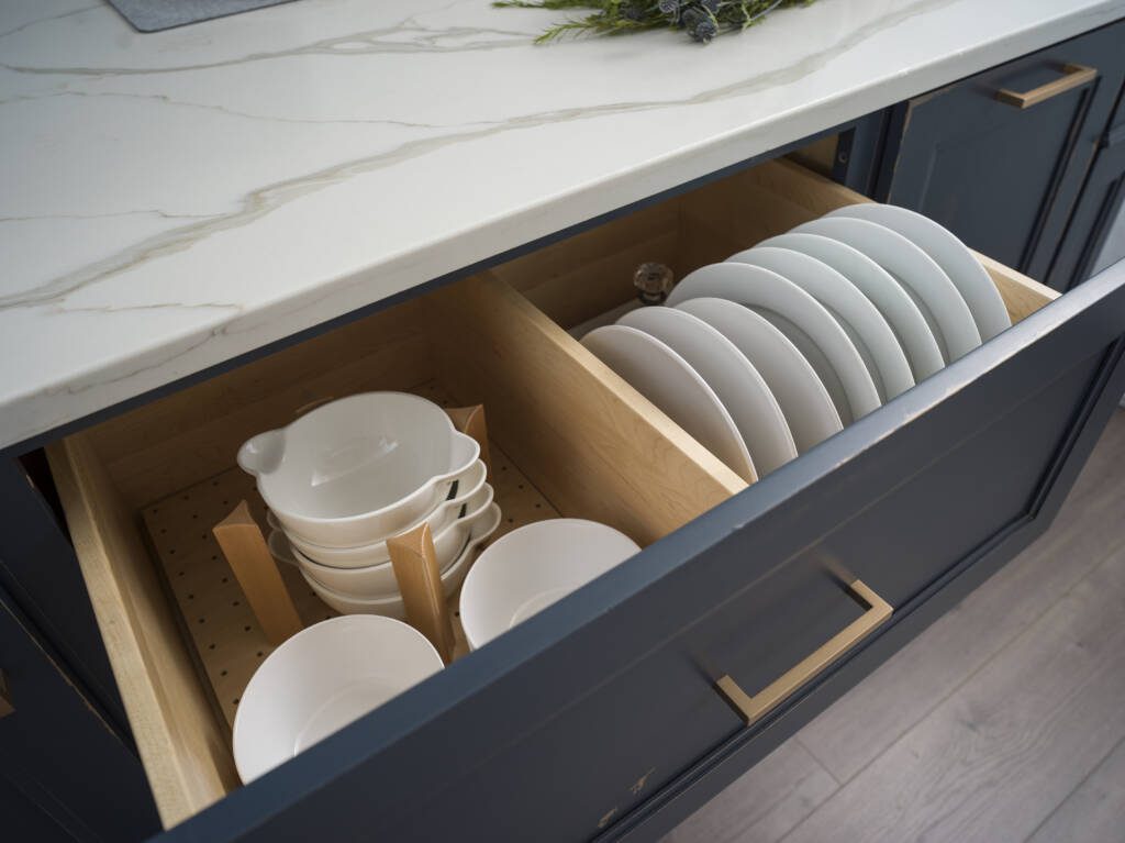 Beautifully Functional Cabinetry -Southlake’s trusted luxury remodeling experts Deep drawer with peg organizers for cookware in Southlake kitchen remodel