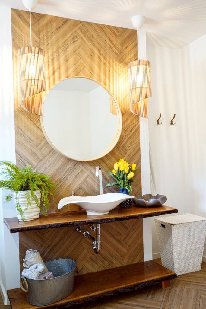 Live-edge wood vanity with herringbone wood-look tile accent wall