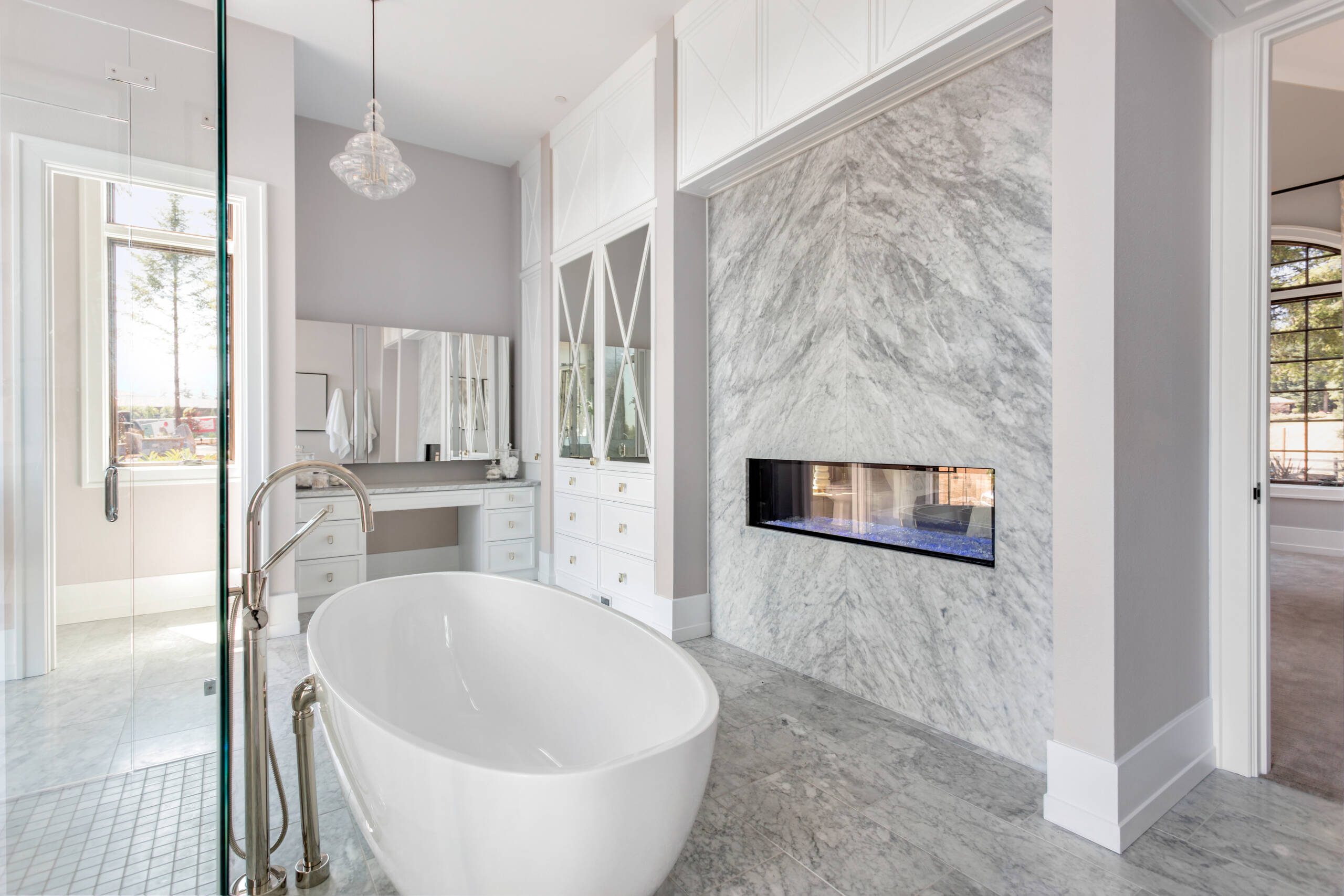 Water and Fire Mitigation and Restoration -Southlake’s trusted luxury remodeling experts Elegant freestanding tub with marble flooring – Southlake luxury bathroom remodel