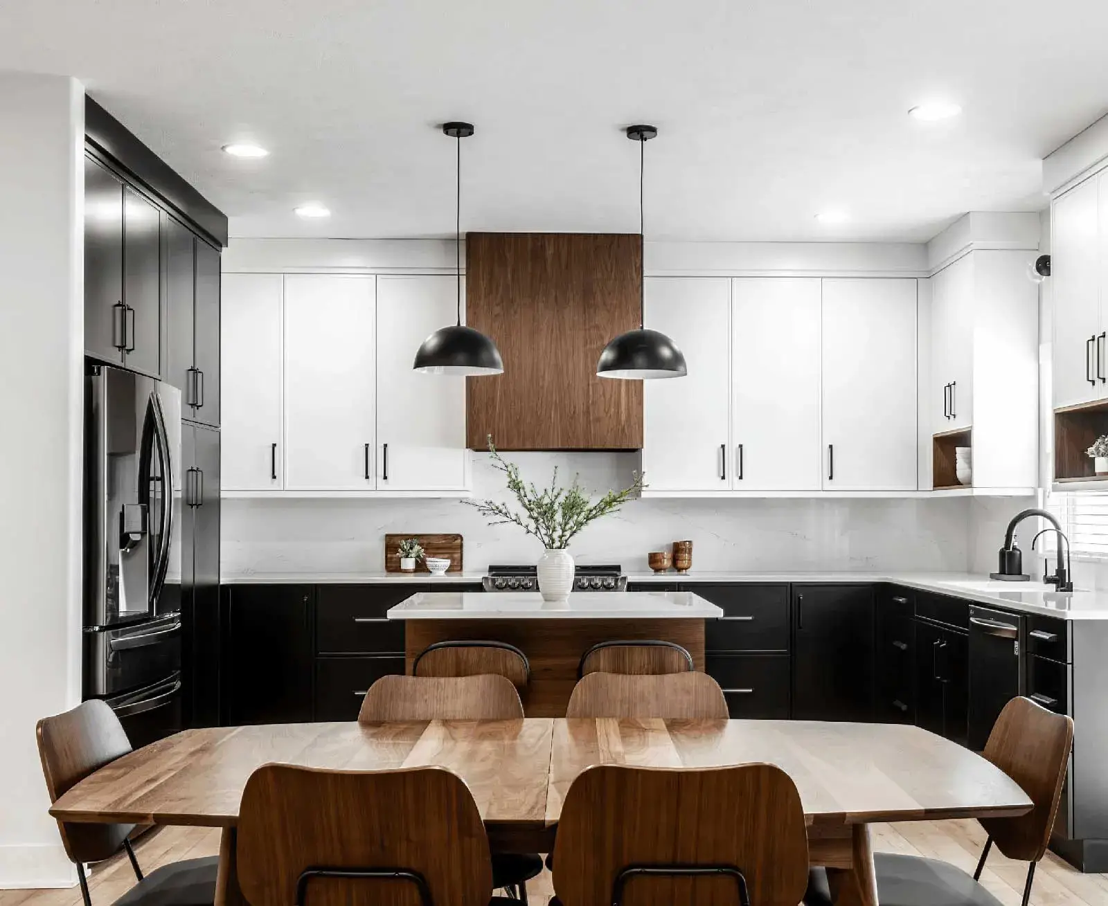 Elevated Contrast with Slim Shaker Style -Southlake’s trusted luxury remodeling experts Luxury kitchen remodel in Southlake, TX featuring slim shaker cabinets in black, white, and walnut wood tones with quartz countertops and waterfall island