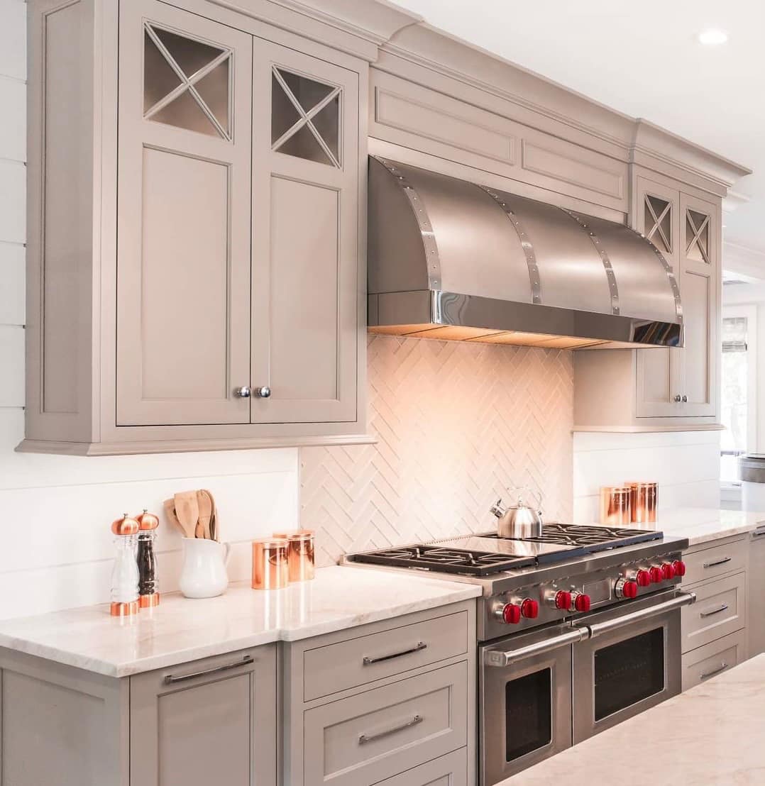 Range Hood Elegance -Southlake’s trusted luxury remodeling experts Brushed Brass Range Hood with Riveted Detail in Southlake Home