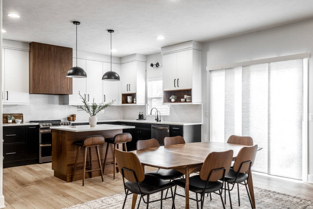 Elevated Contrast with Slim Shaker Style -Southlake’s trusted luxury remodeling experts Luxury kitchen remodel in Southlake, TX featuring slim shaker cabinets in black, white, and walnut wood tones with quartz countertops and waterfall island