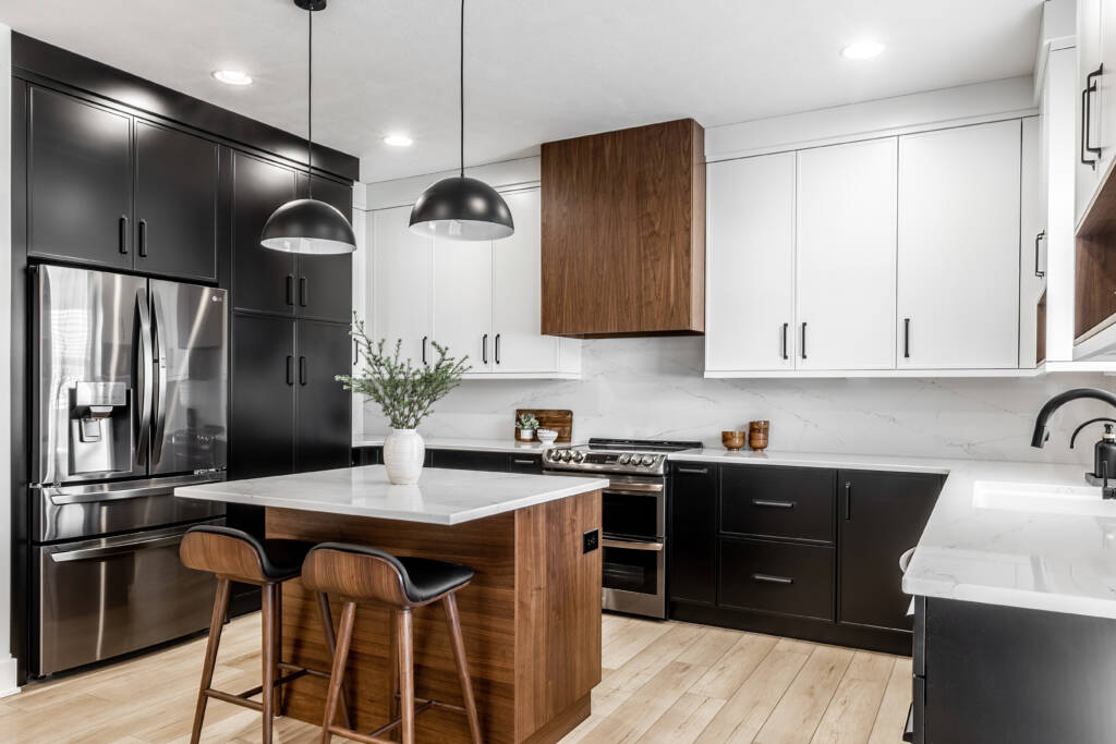 Elevated Contrast with Slim Shaker Style -Southlake’s trusted luxury remodeling experts Luxury kitchen remodel in Southlake, TX featuring slim shaker cabinets in black, white, and walnut wood tones with quartz countertops and waterfall island