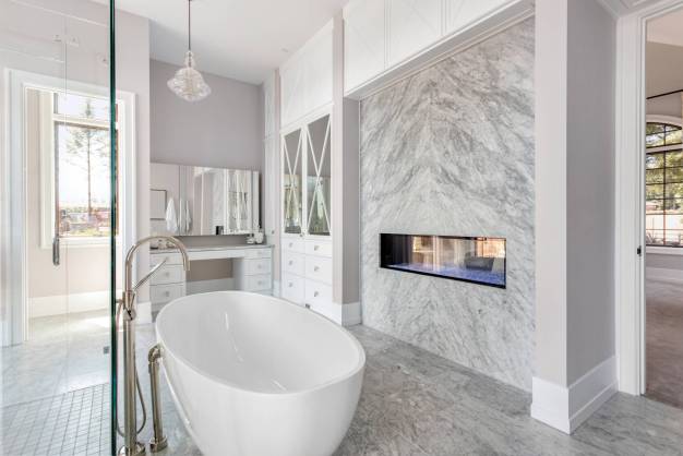 Elegant freestanding tub with marble flooring – Southlake luxury bathroom remodel